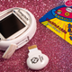 A photo of the Tamagotchi Smart and its TamaSma card